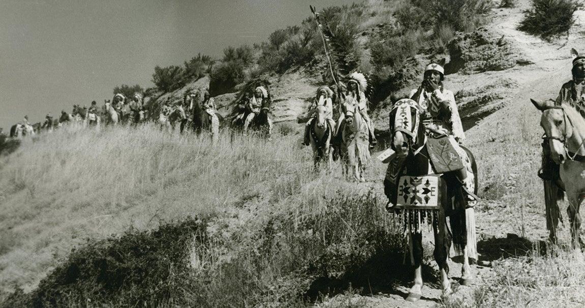 Inidans riding on a trail