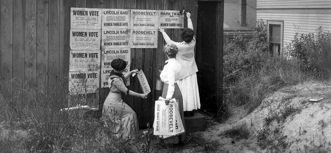 Women putting up posters