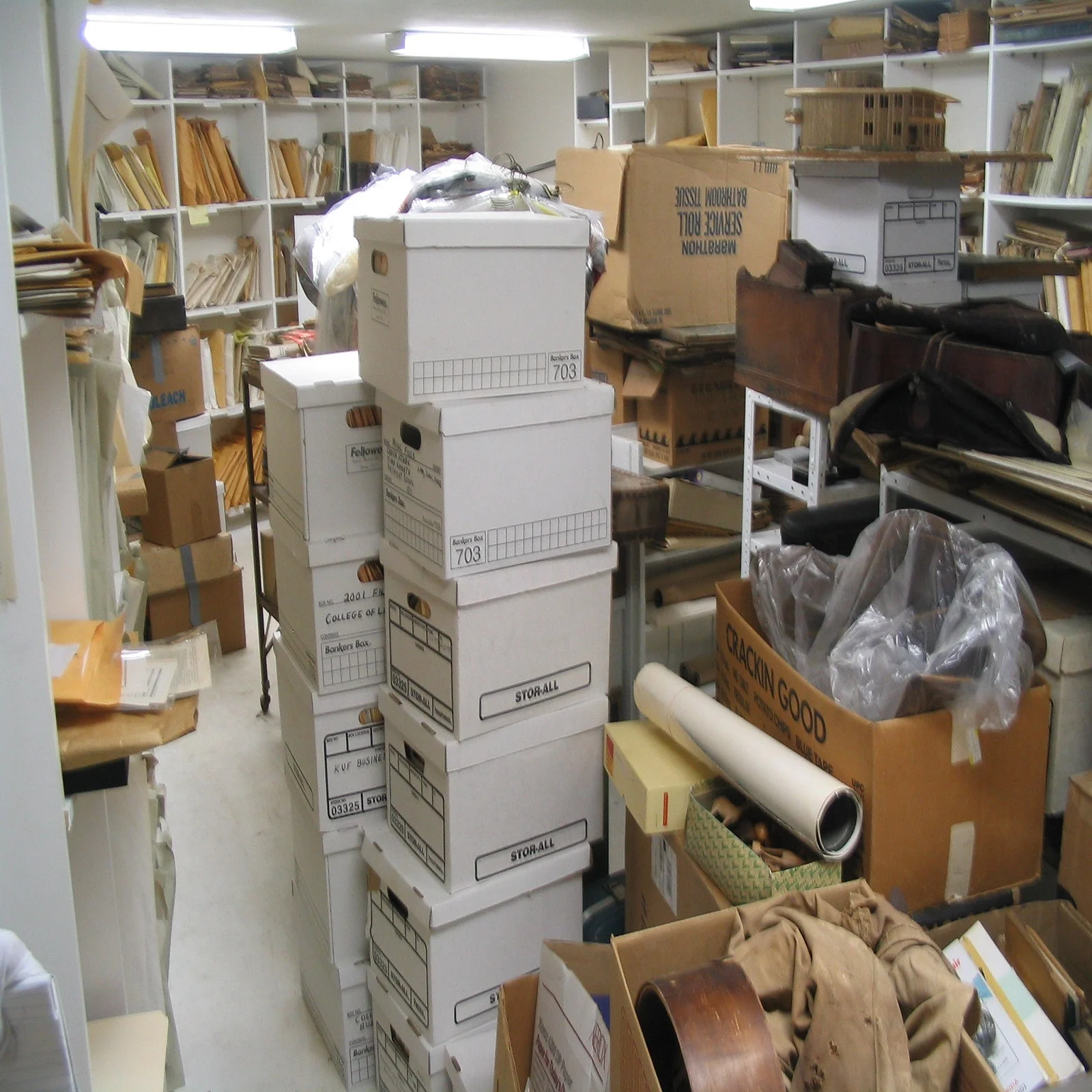 an office room filled with clutter and boxes