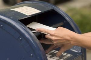 hand putting mail dropbox