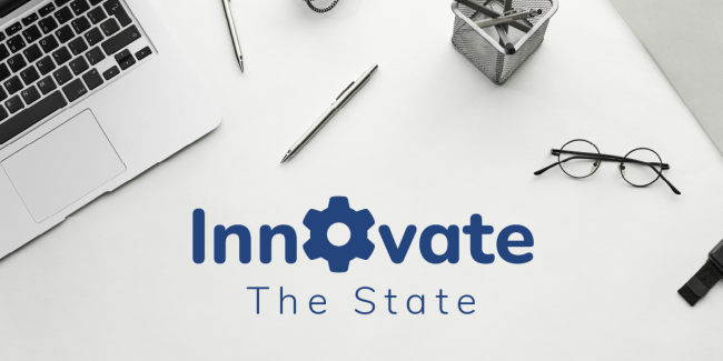 Innovate the State masthead with computer, glasses and pen on a desk